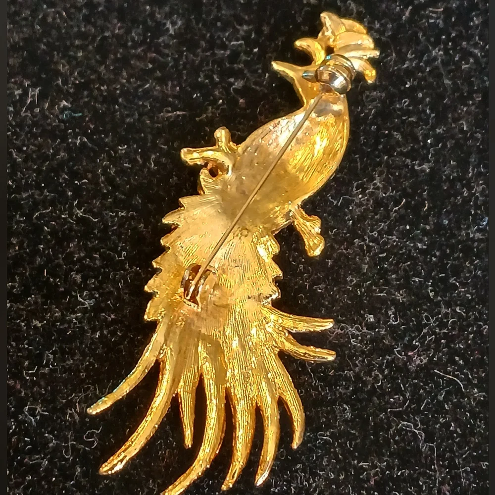 Goldtone peacock brooch with blue and green accents